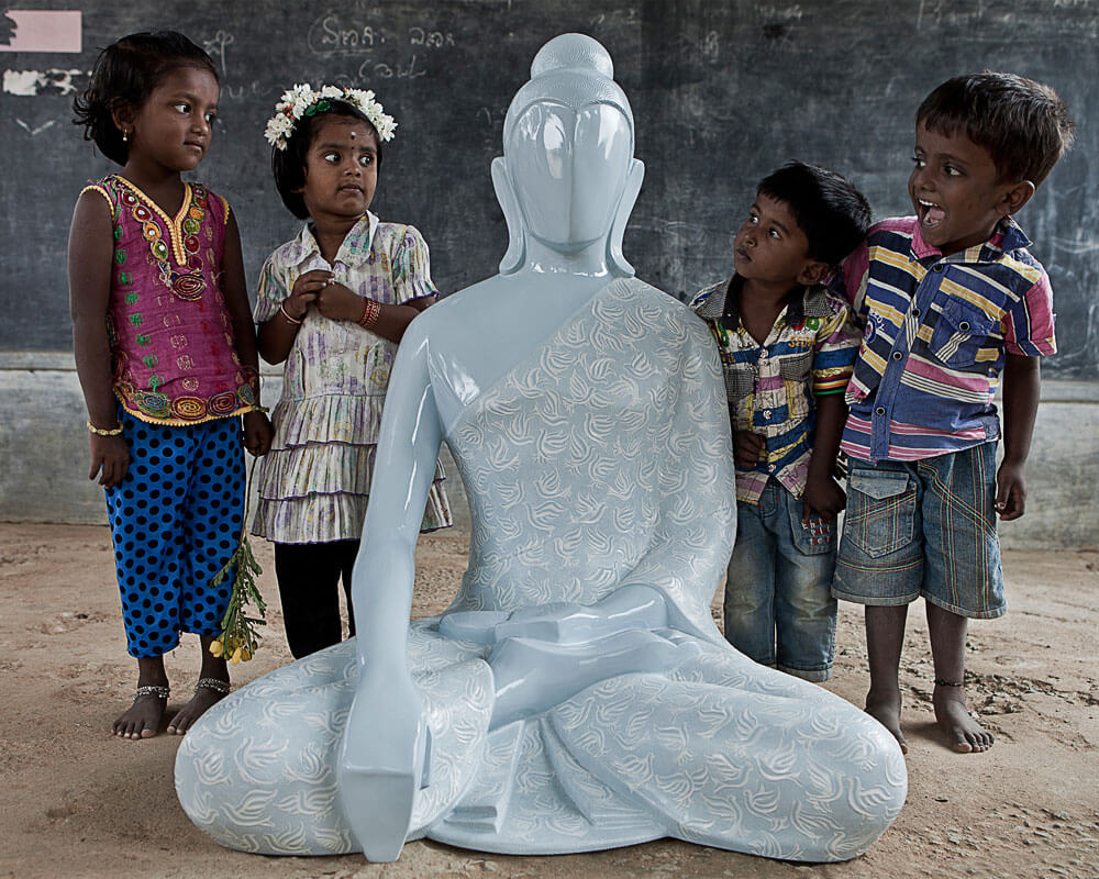 Childrens feeling entusiastic after seeing buddha peace messenger sculpture, sculpted by Sangeeta Abhay
